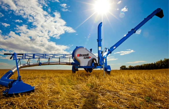Brandt 5200 EX GrainVac, featuring efficient grain recovery and powerful suction in a wheat field.