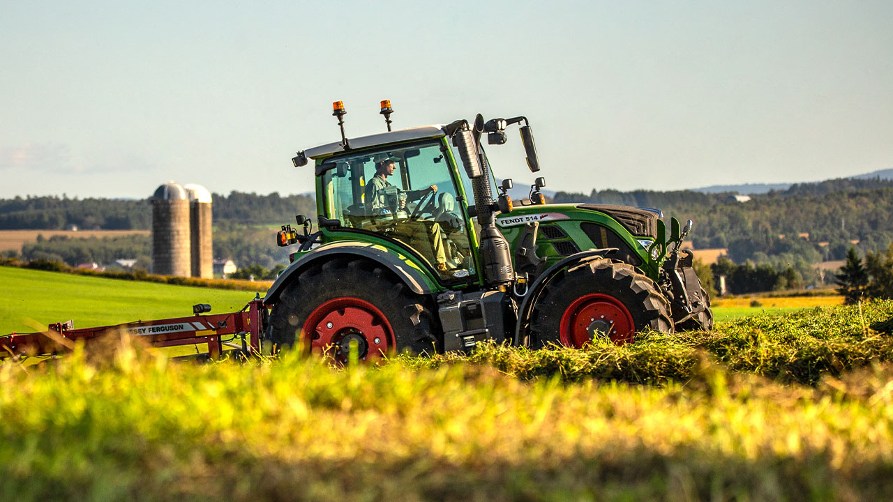 Fendt 500 Vario tractor towing Massey Ferguson implement across hilly pasture, ideal for AGCO precision and mid-size farm operations.