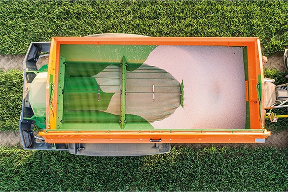Aerial view of Amazone ZG-TS spreader filled with granular fertilizer, showcasing precise metering system and large hopper capacity.