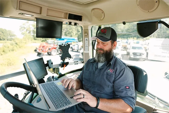 AgRevolution technician inside cab of mobile service truck.