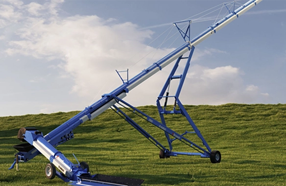 Brandt GrainDeck with integrated auger system, positioned for efficient grain loading on a hillside.