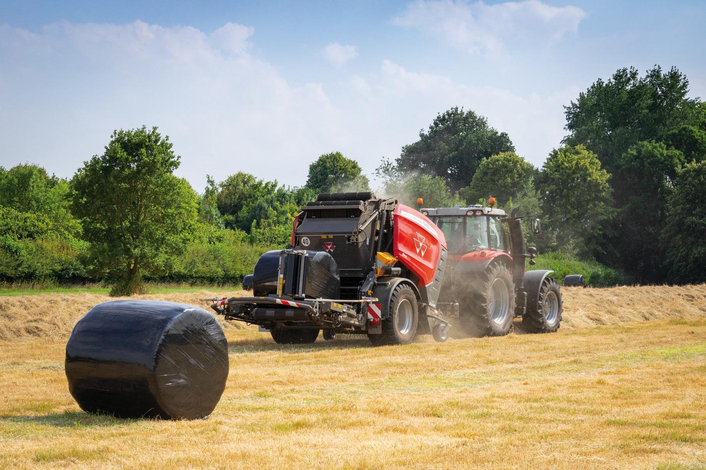 Massey Ferguson RB V PROTEC baler wrapping silage bale in-field, towed by MF tractor for efficient hay and forage production.