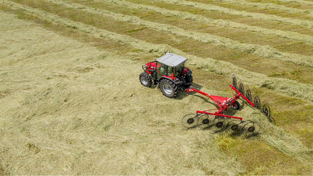 Aerial view of Massey Ferguson tractor operating MF RK V Series Wheel Rake in hayfield, delivering high-capacity raking and clean windrows.