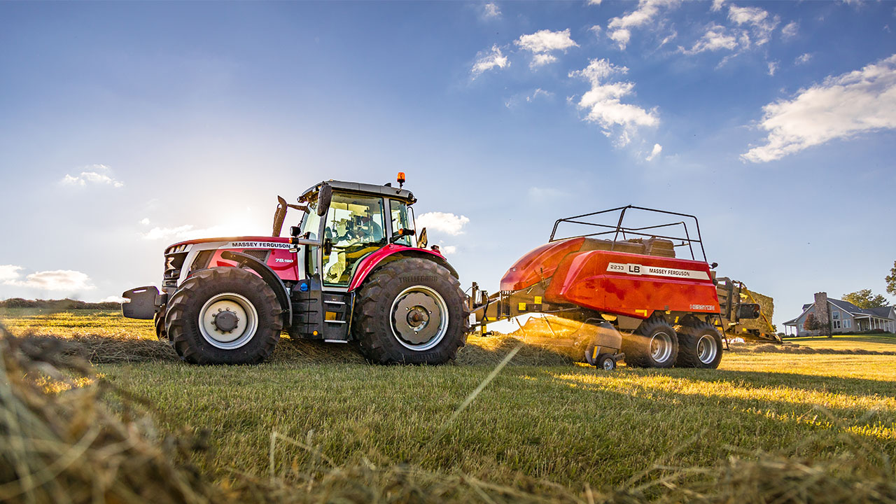 Massey Ferguson 7S Series tractor with LB2233 large square baler operating in a hayfield, ideal for high-efficiency baling.