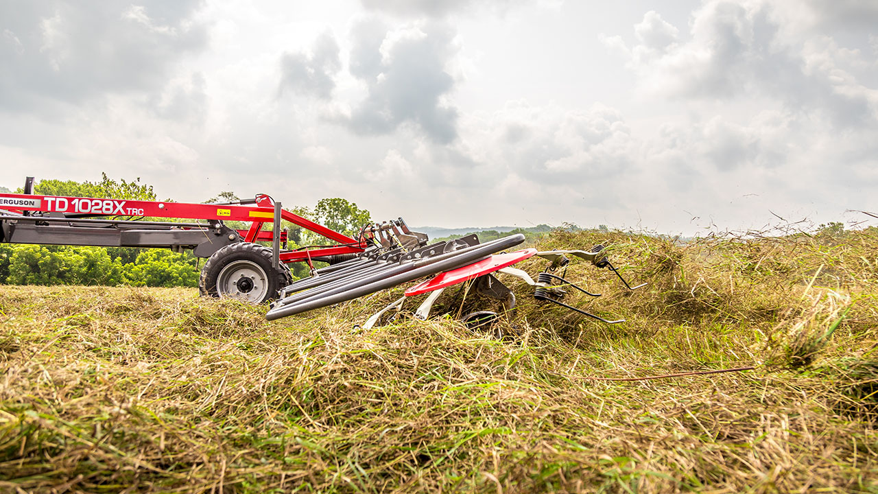 Massey Ferguson TDX Series Tedder spreading hay in the field.
