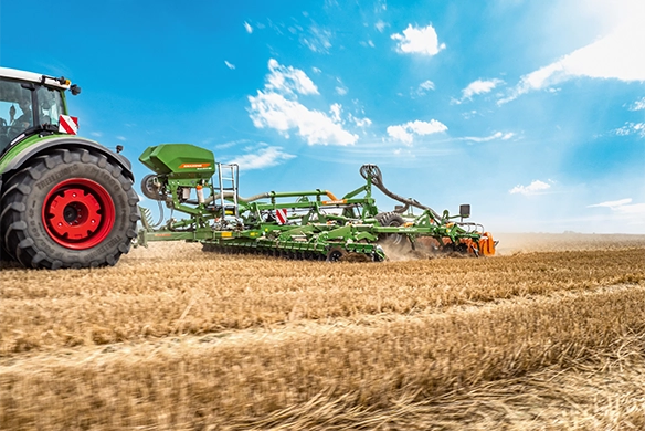 Side-angle view of Amazone Ceus in action with multiple working zones for primary and secondary tillage.