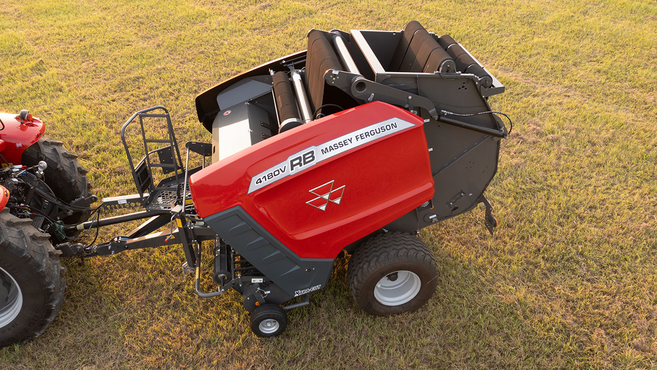 Top view of Massey Ferguson RB 4180V in field, showing open chamber and hitch to tractor.