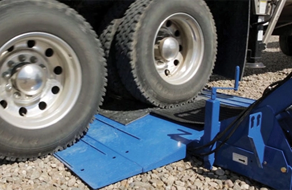 Truck wheels rolling over Brandt GrainDeck, emphasizing durable construction for long-term field use.