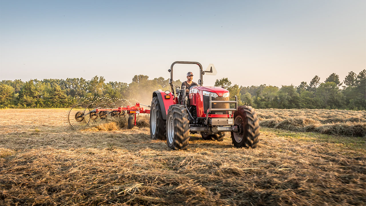 Massey Ferguson tractor operating MF RK V Series Wheel Rake in hayfield, delivering high-capacity raking and clean windrows.