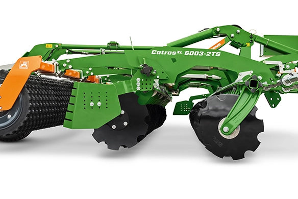 Side view of Amazone CatrosXL 6003-2TS with sharp serrated discs and roller system for intensive shallow tillage and surface mixing.