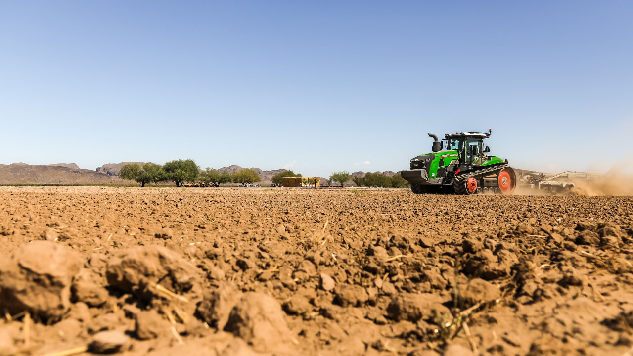 Fendt 1100 Vario MT tractor with tracks working a dusty field, showcasing high-power tillage and precision farming performance.