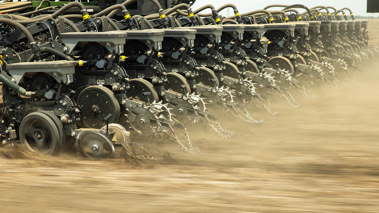 Close-up of Fendt Momentum planter row units showcasing precision AGCO planting technology and high-efficiency components.