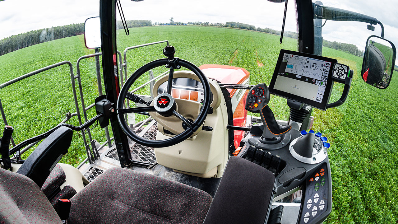 Interior cab view of a Massey Ferguson sprayer showing advanced controls, joystick, and field-ready precision technology.