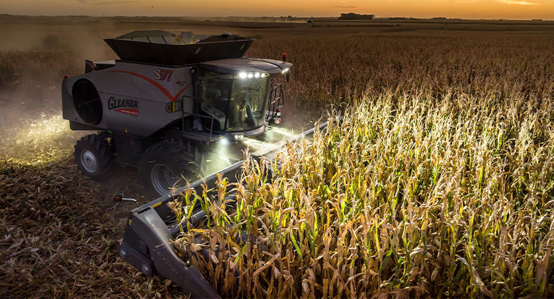 Gleaner 3300 Command Series combine harvesting corn at dusk with LED lights, built for performance and late-day productivity.
