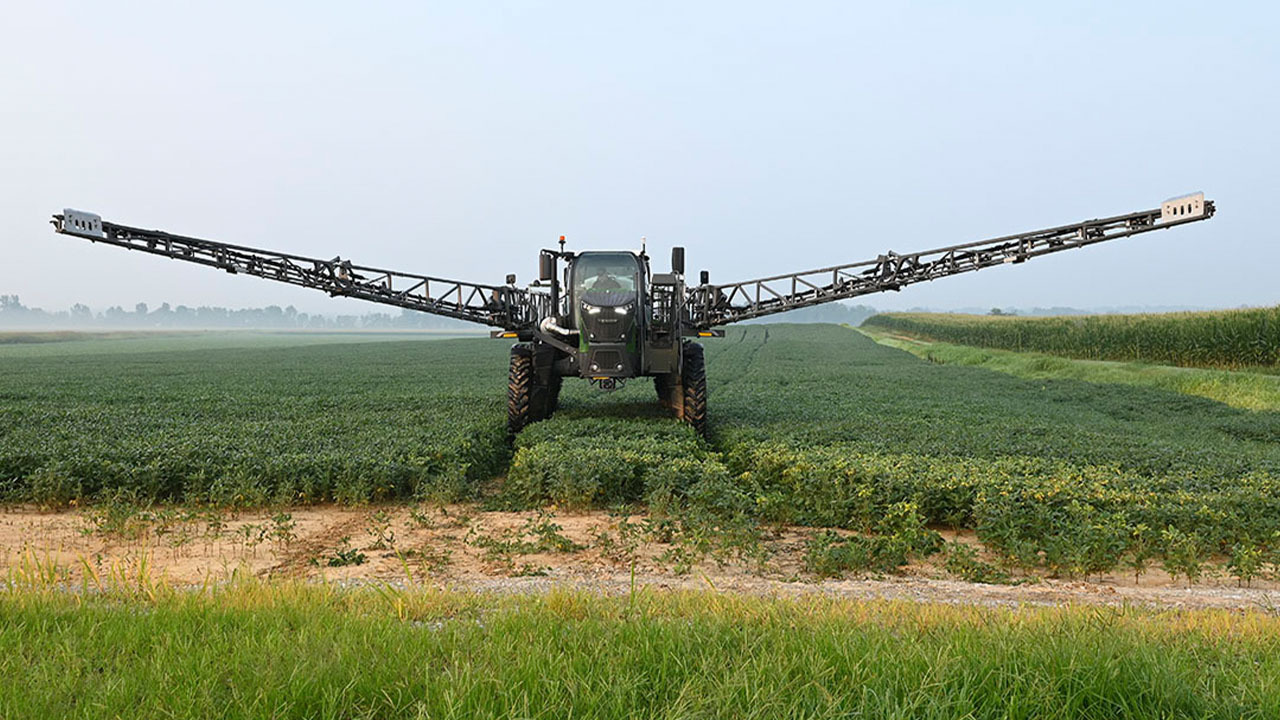Fendt Rogator 900 sprayer in soybean field with extended boom, precision farming equipment, AGCO application technology.