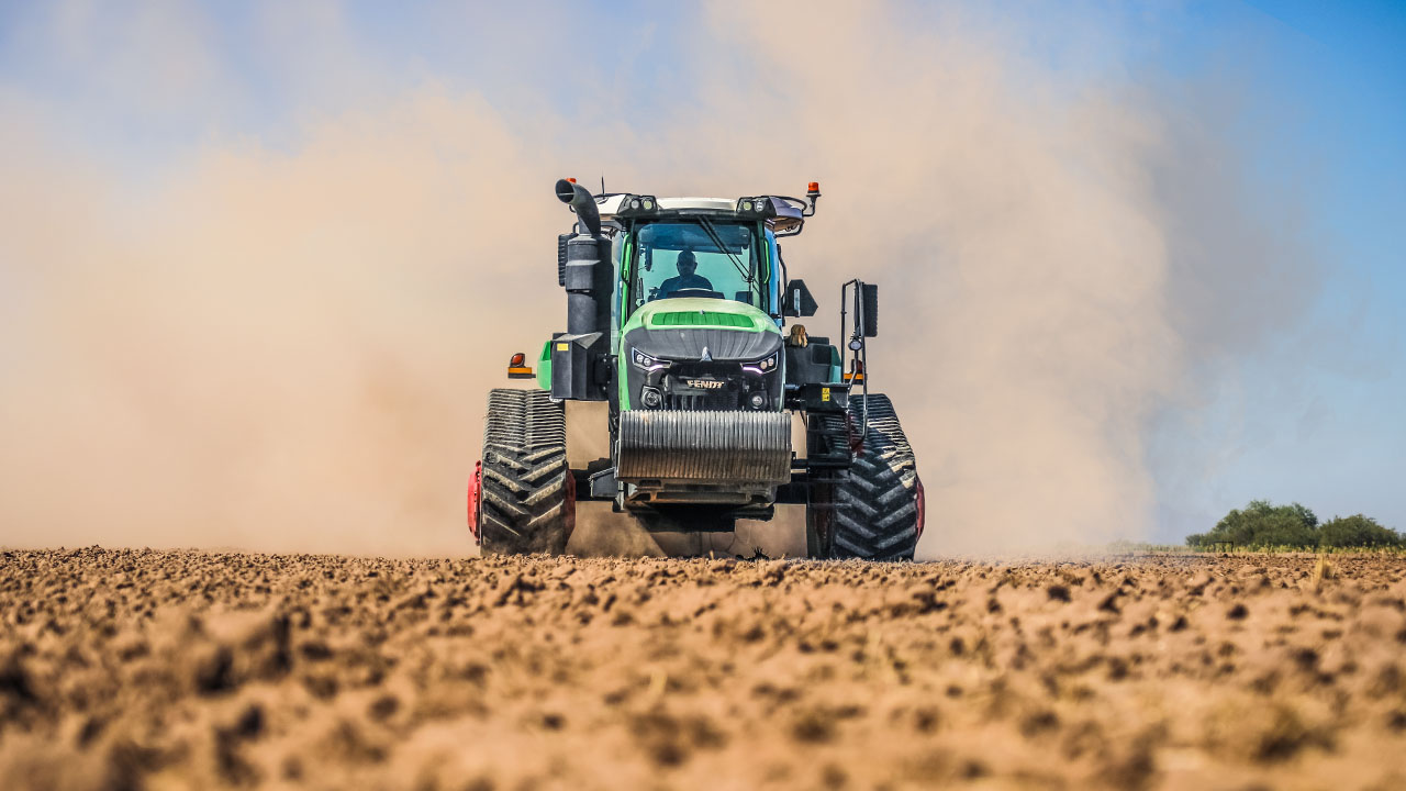 Fendt 1100 Vario MT tractor with tracks working a dusty field, showcasing high-power tillage and precision farming performance.